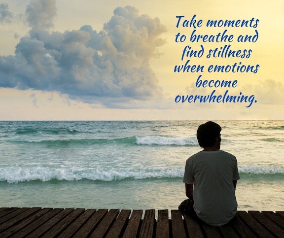 The silhouette of a man sitting on a pier looking over the ocean with a quote about grief.