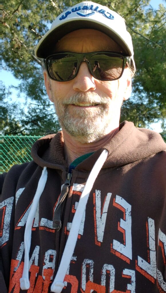 Man in sunglasses, hat and sweater