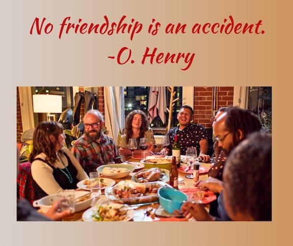 Friends sit around a dinner table. The words No friendship is an accident is at the top of the image