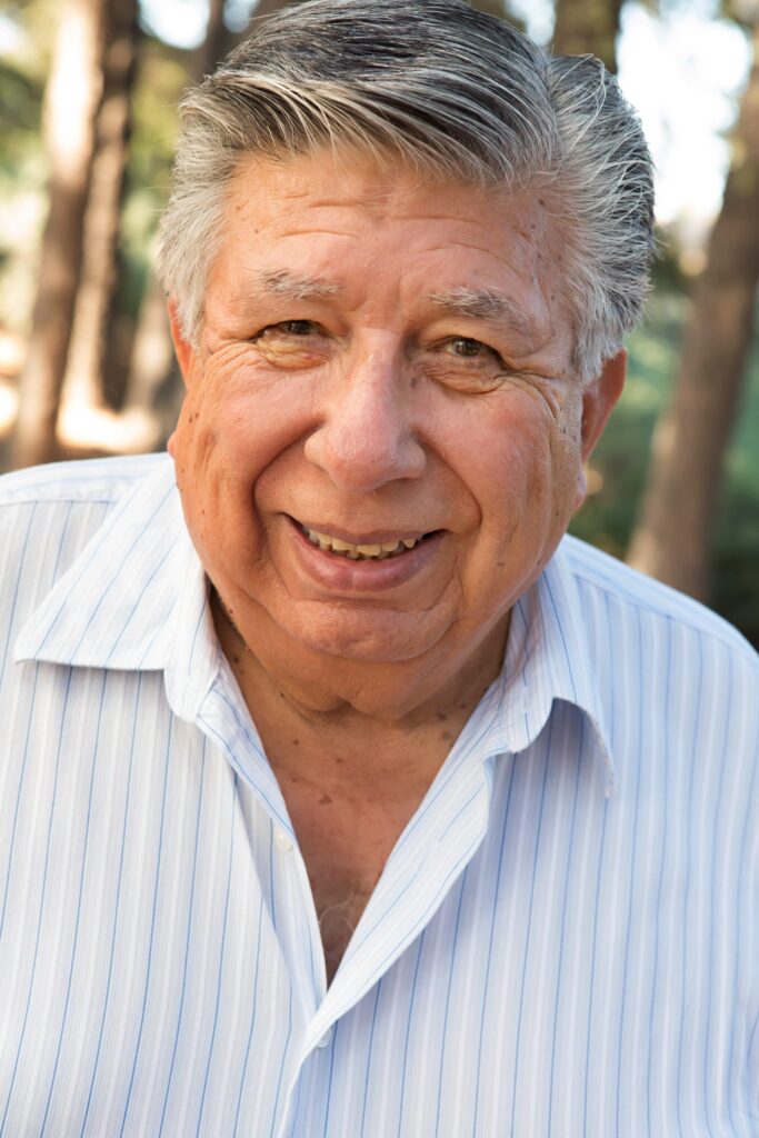 Man with gray hair wearing a striped shirt