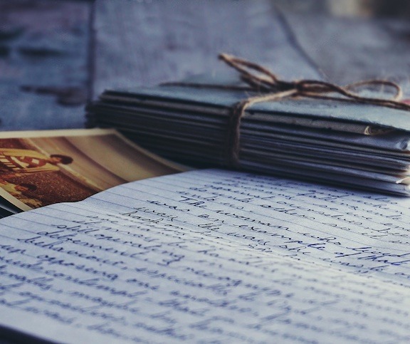 A pile of handwritten letters including a page with a written page.