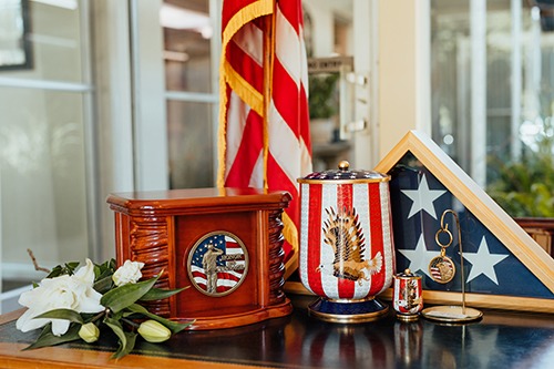 Flag urns and urn keepsakes displayed on a table